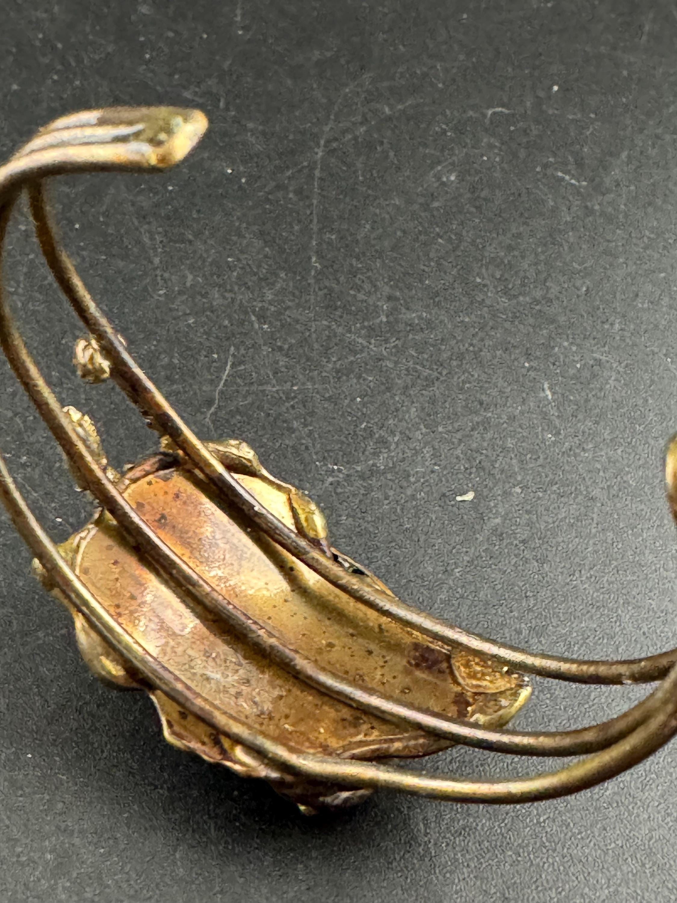 Artisan brass open bangle, set with green glass cabochon