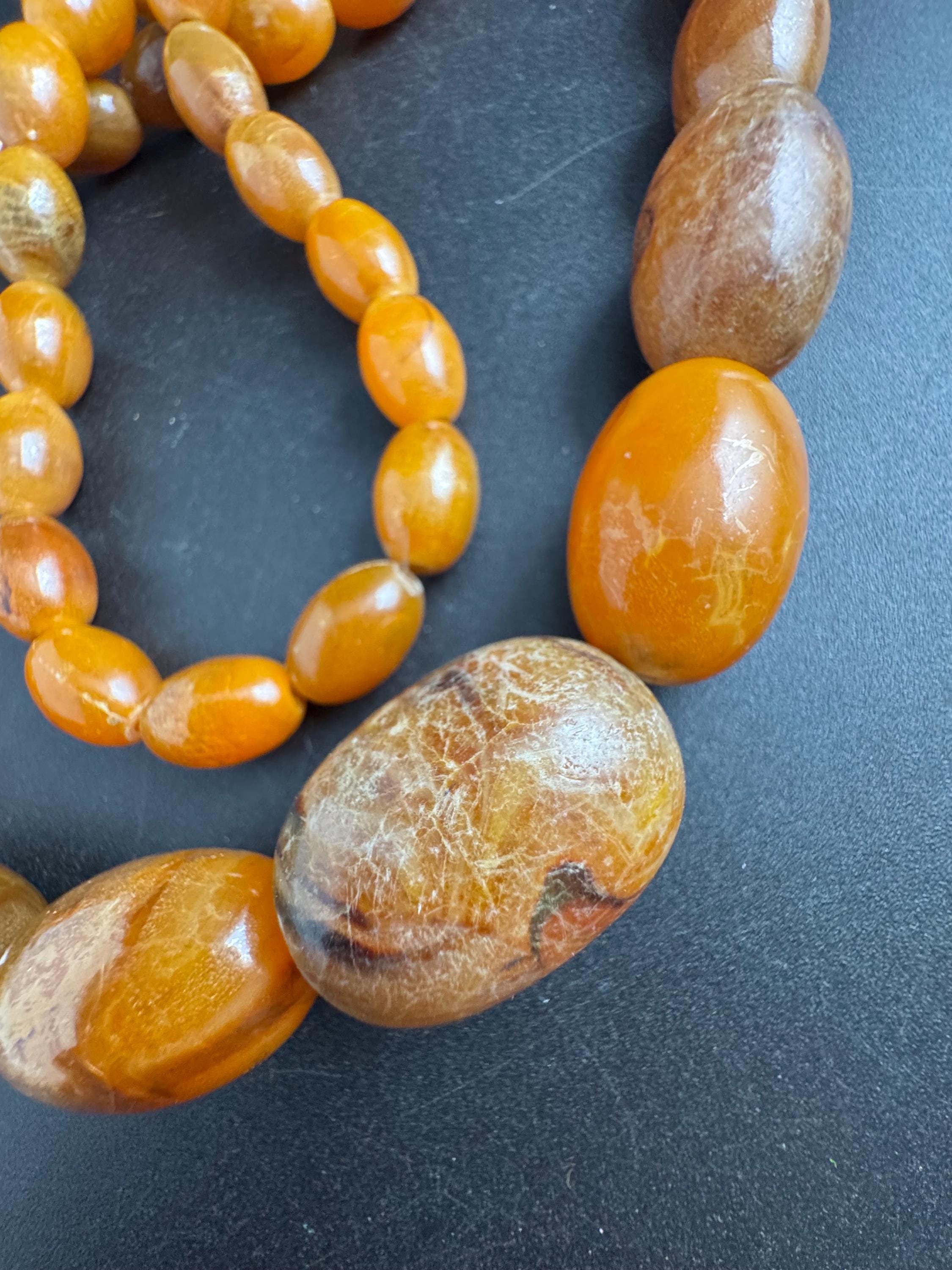 Long Faux Amber orange brown beaded necklace, oval plastic beads