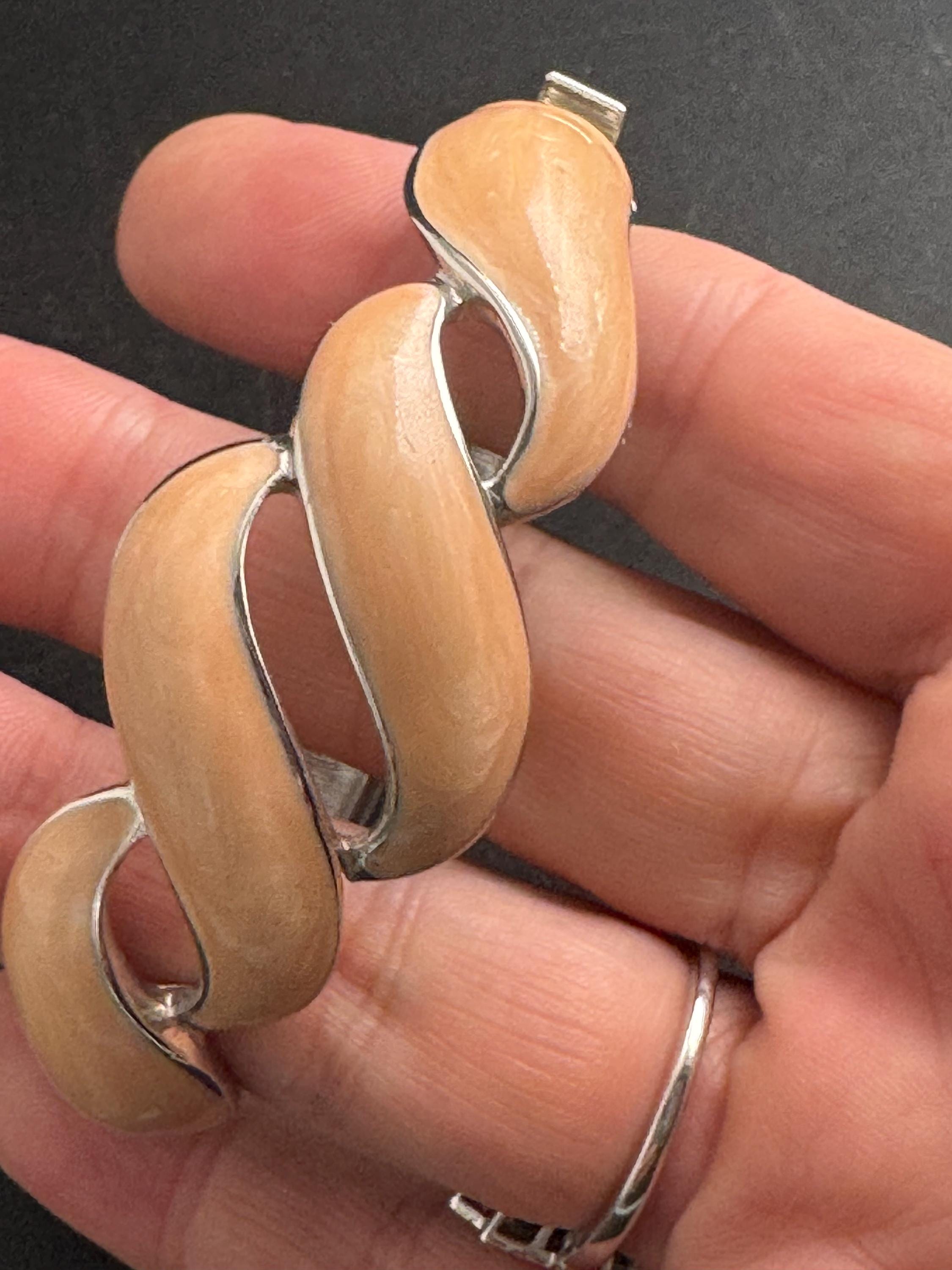 Beige enamel Monet bangle , silver tone clamper and signed