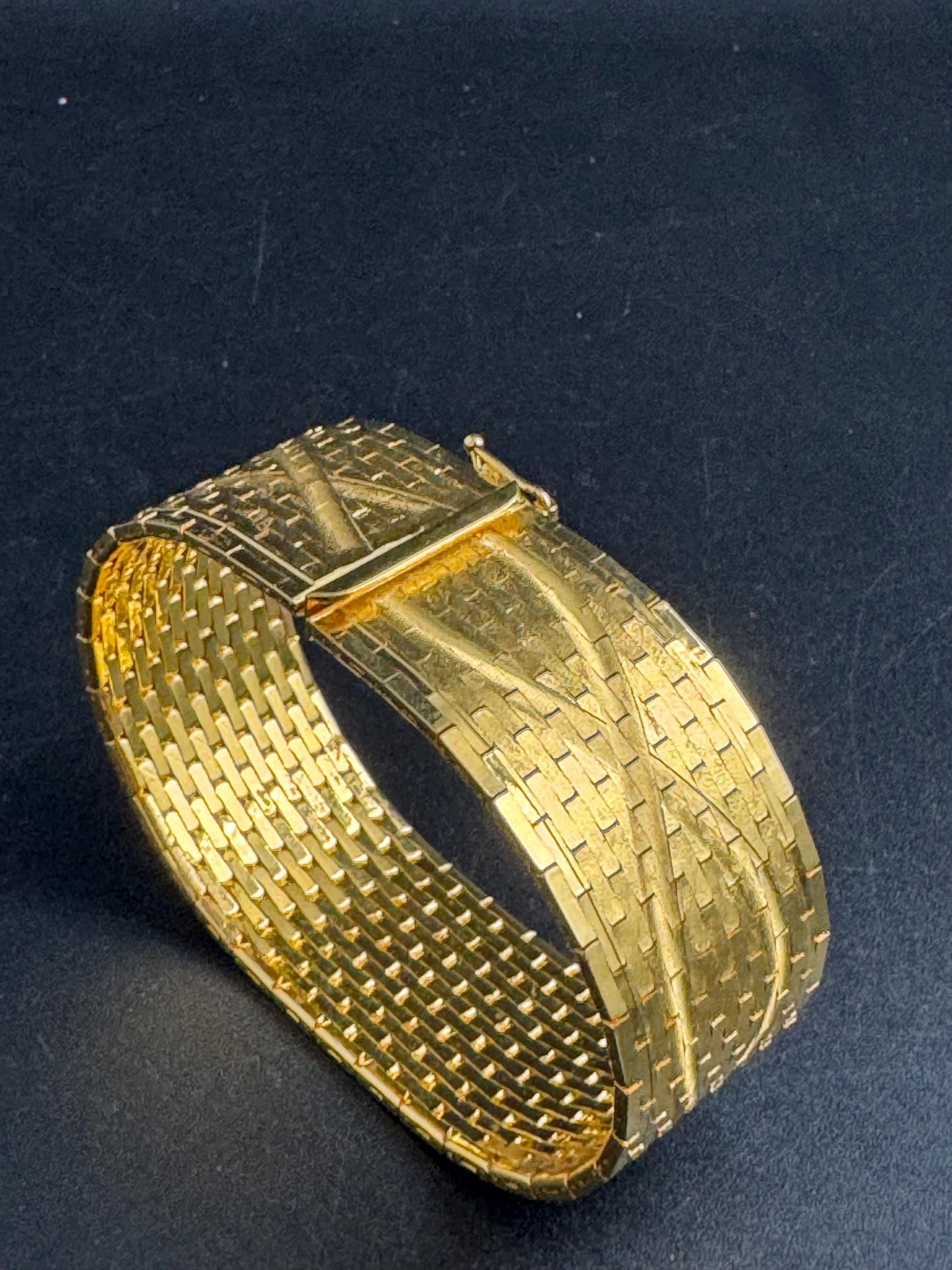 Wide gold plated flat bracelet, articulated 1970s