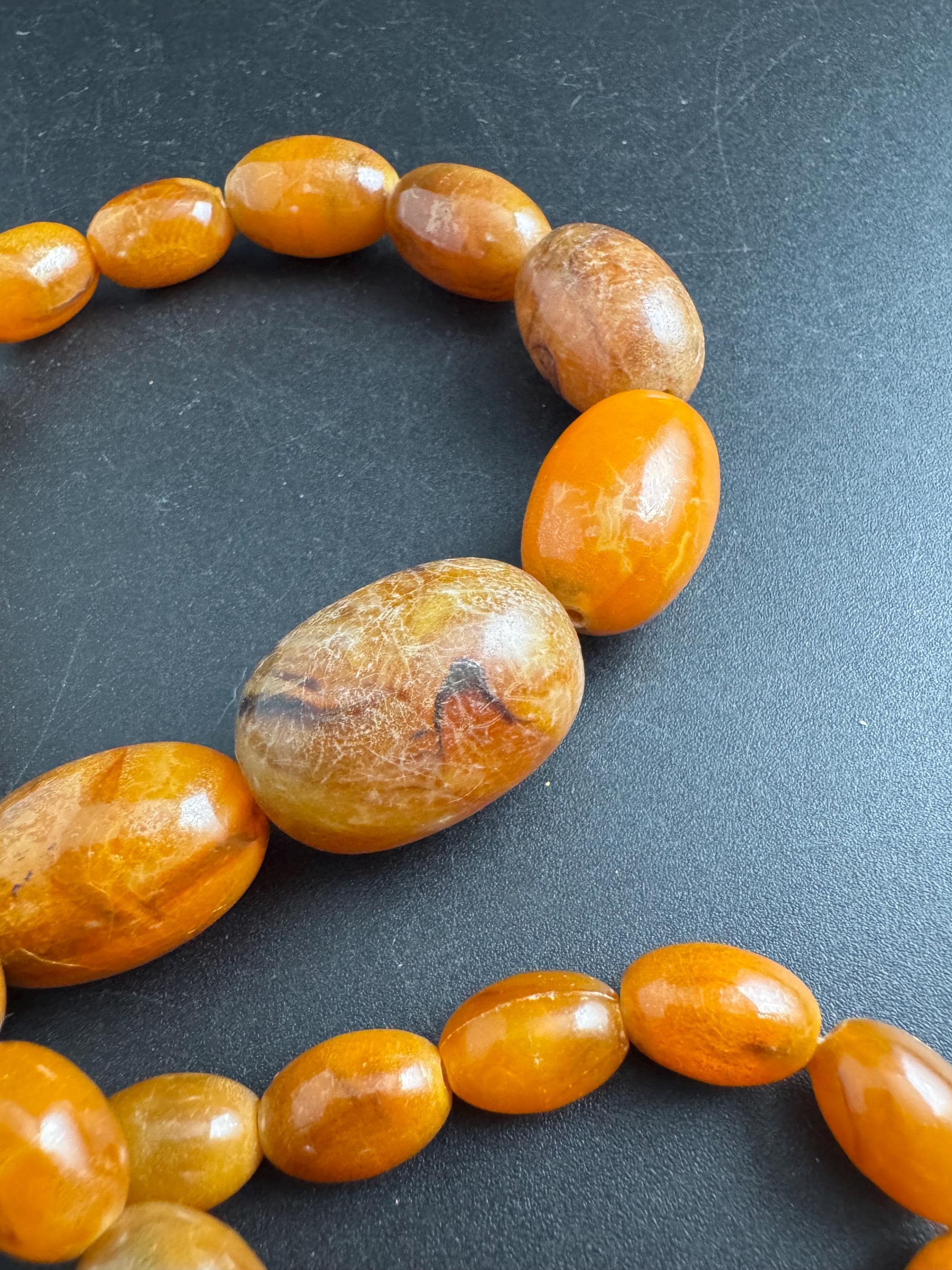 Long Faux Amber orange brown beaded necklace, oval plastic beads