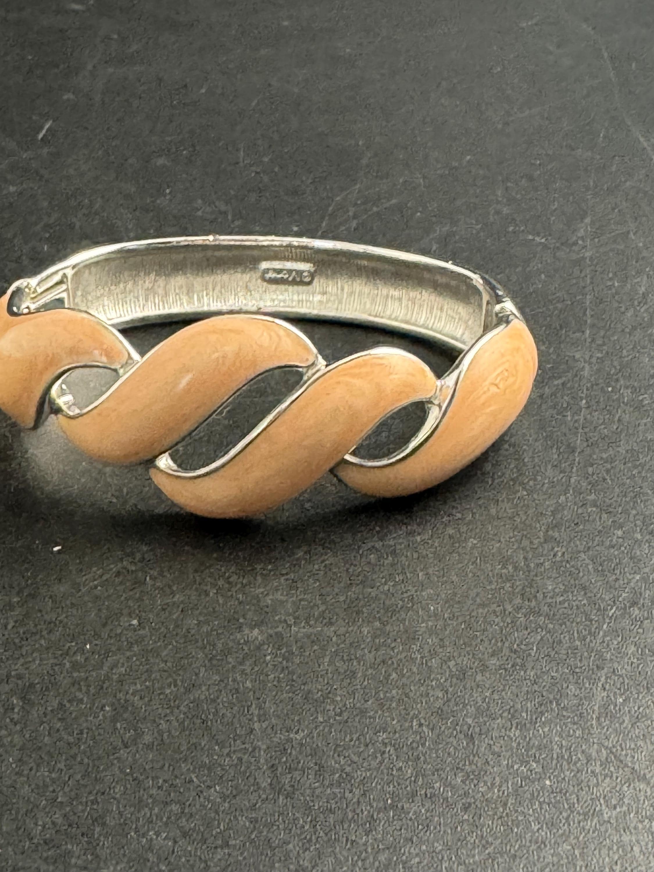 Beige enamel Monet bangle , silver tone clamper and signed