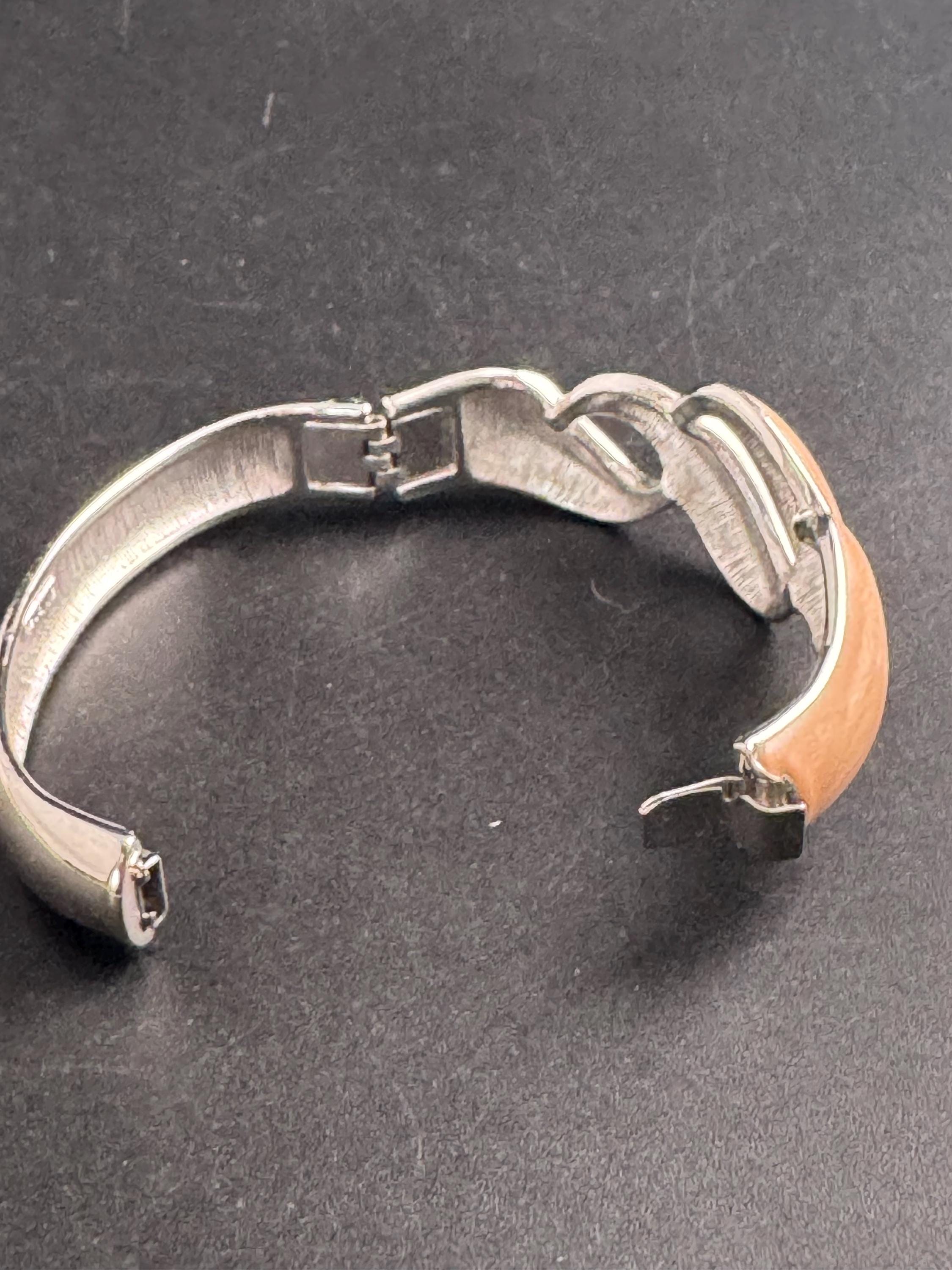 Beige enamel Monet bangle , silver tone clamper and signed