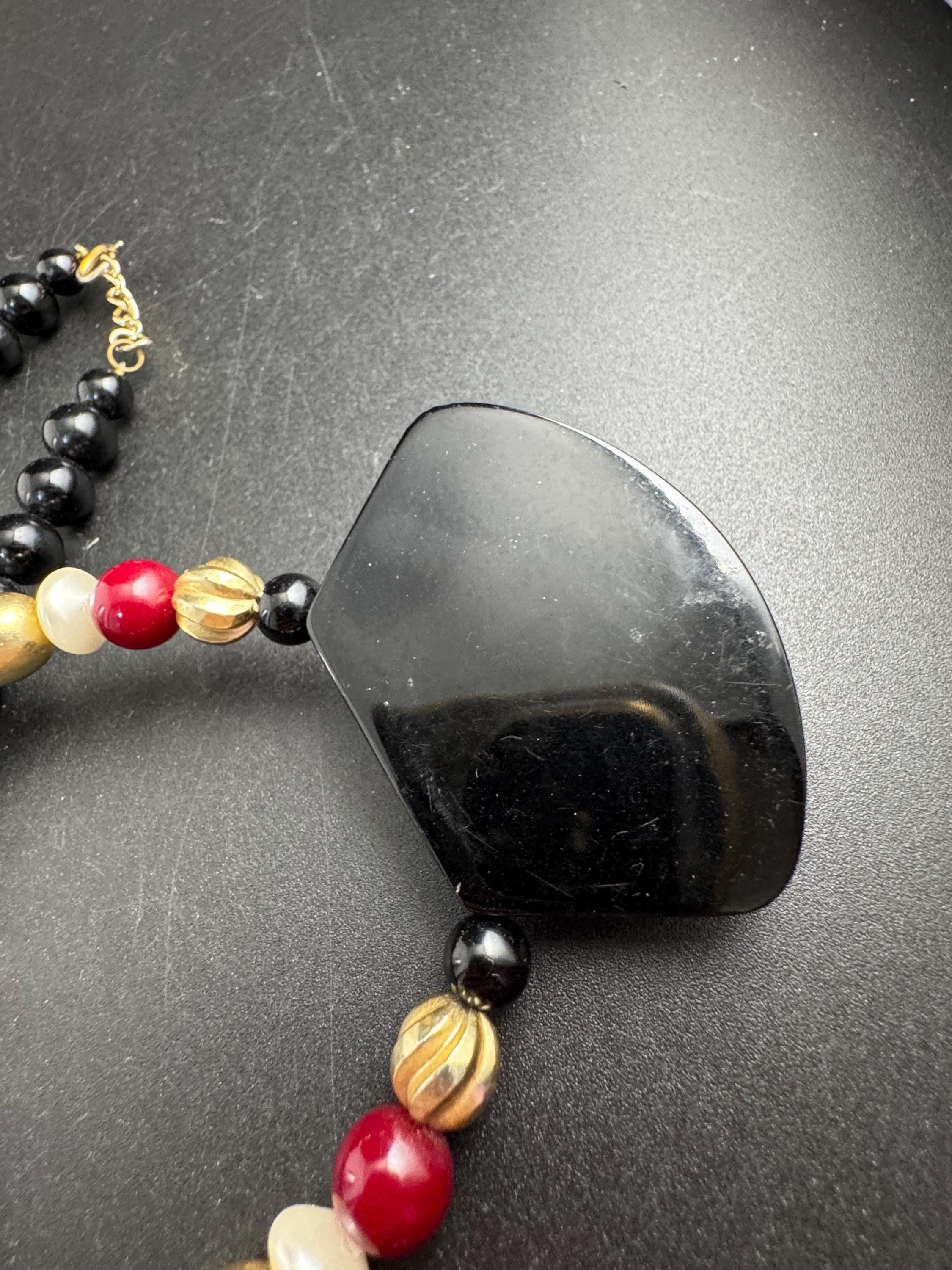Black beaded statement necklace, red gold acrylic pendant