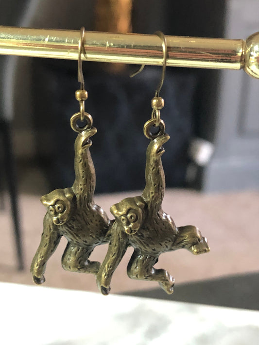 Antique gold tone hanging monkey drop earrings