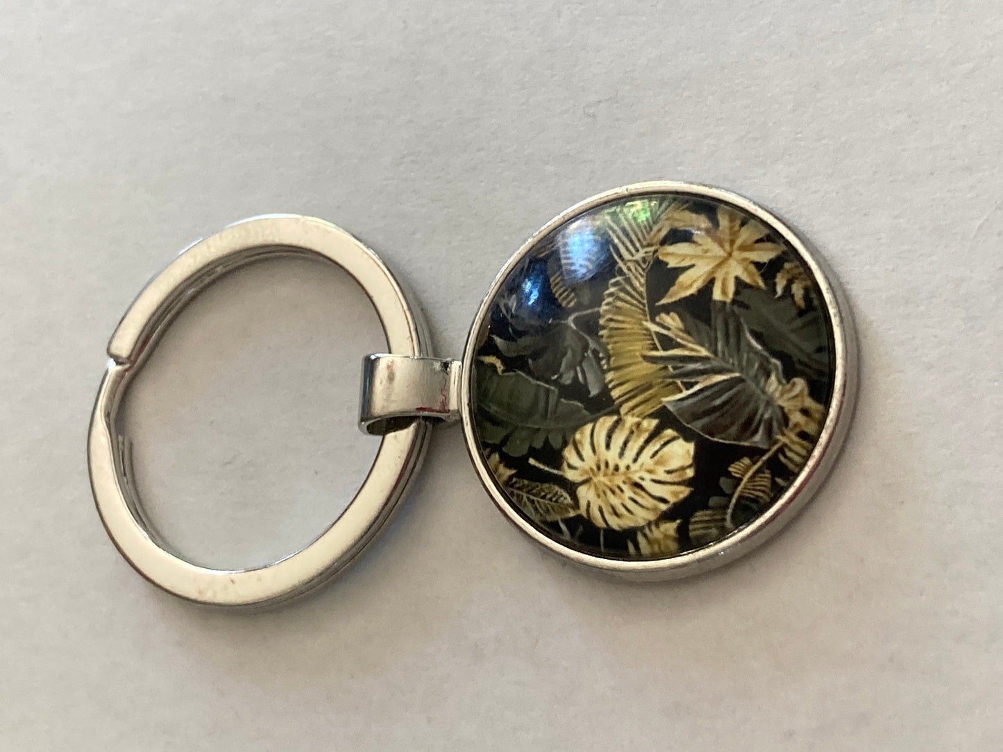 Designer style black and gold palm tree print silver tone keyring with 25mm glass cabochon