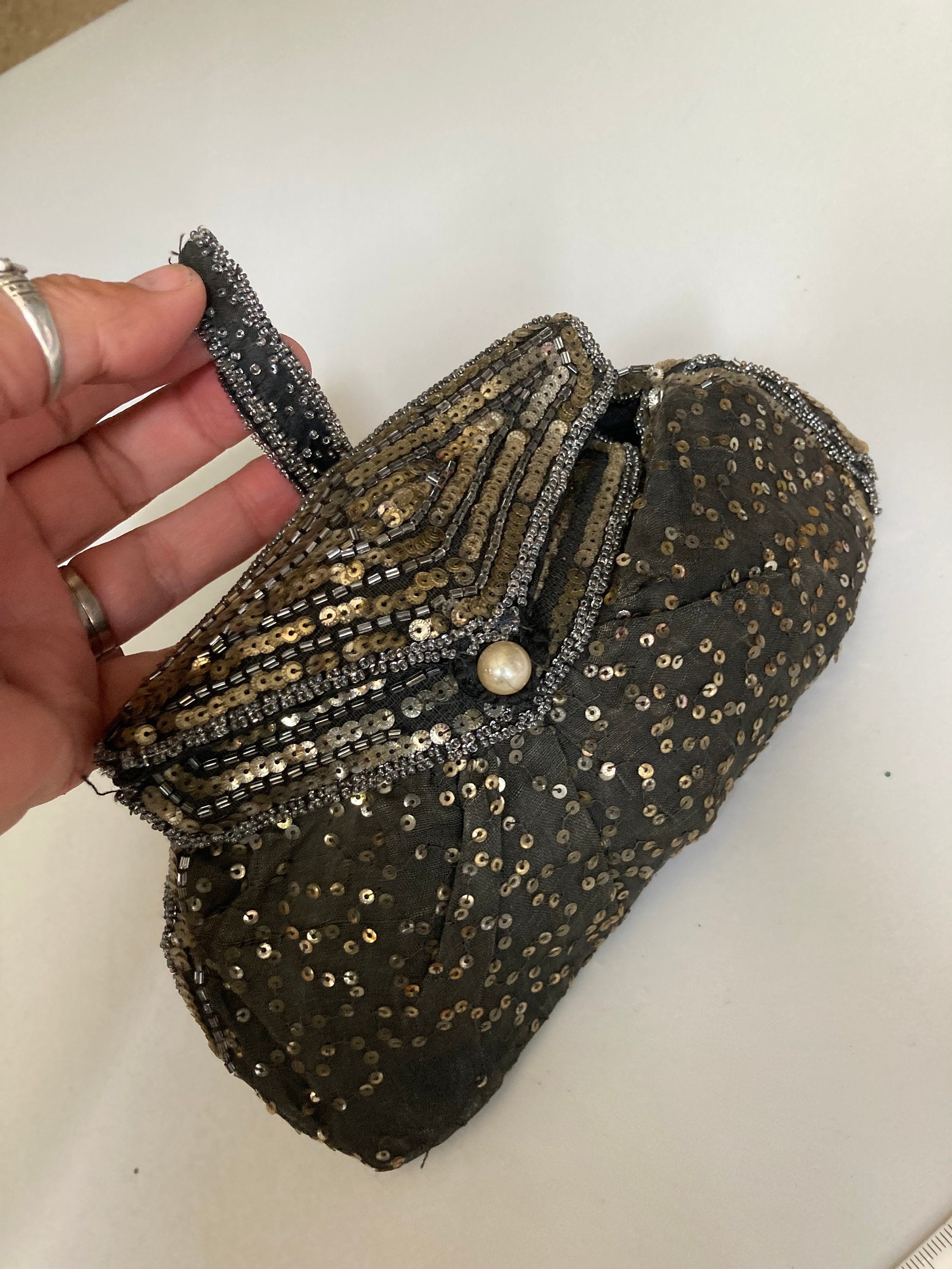 Black evening clutch bag with gold rhinestones | INVITADISIMA